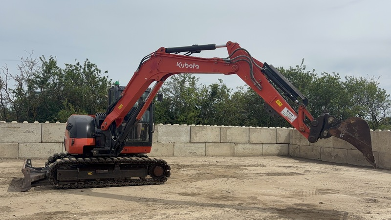 Kubota mini excavator with thumb attachment parked and ready for tree removal or land clearing work